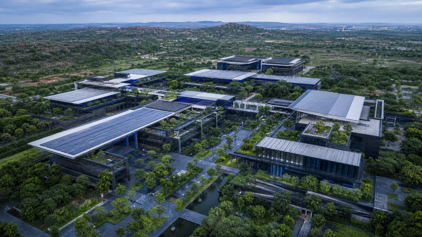 Illustrative Hyderabad science campus aerial with graphite basalt and shaded courtyards in cool post-monsoon light